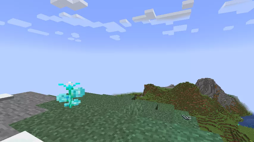 青空の下、1本のミラージュフラワーの生える吹きさらしの丘と、遠景に平原や山が見える様子